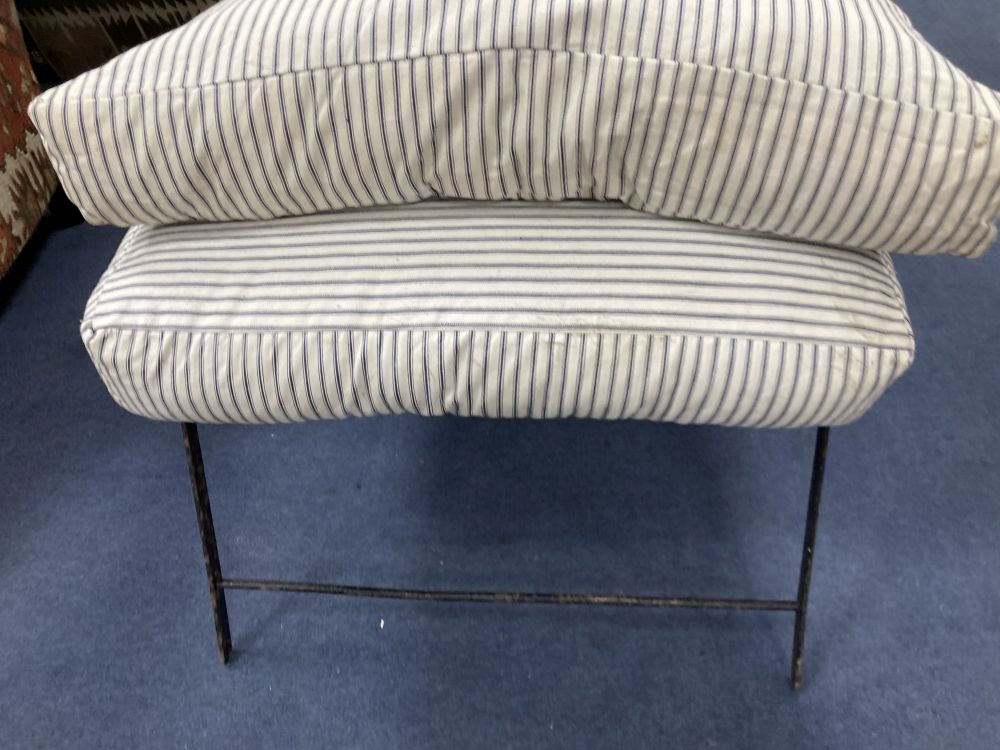 A Victorian wrought iron folding armchair with loose cushion seat and back